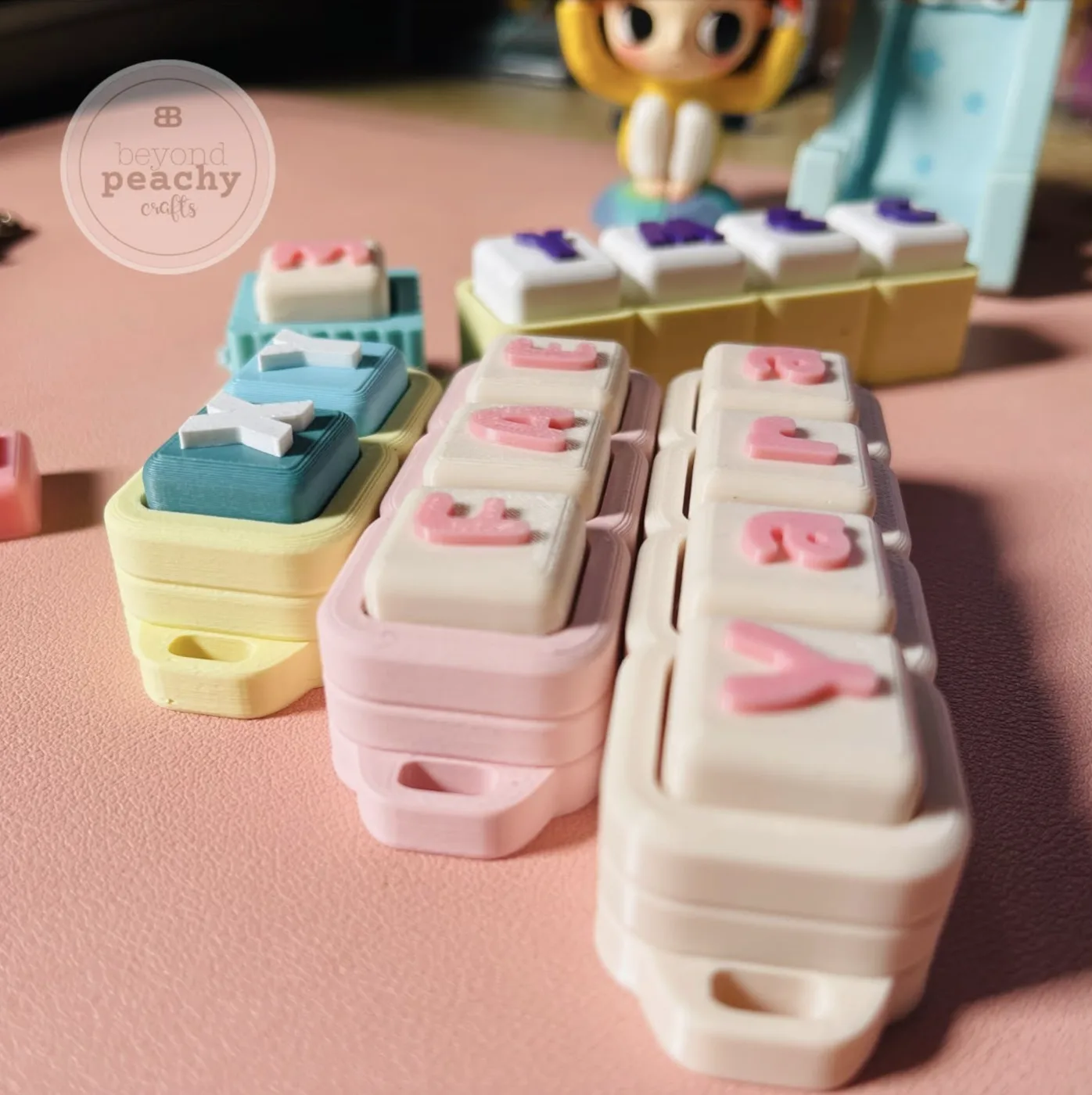 Close-up of handmade pastel letter blocks
